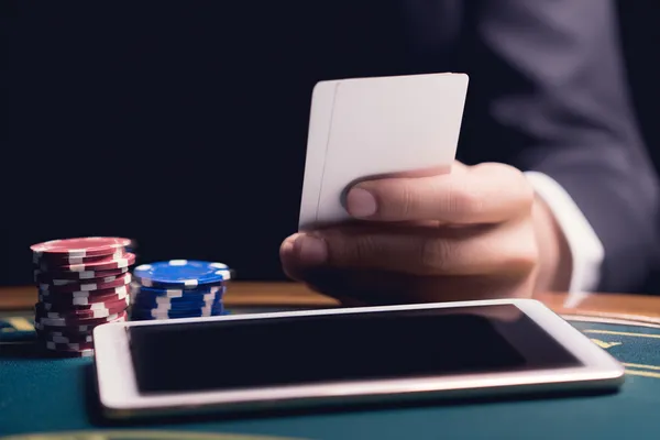 A young woman relaxing with her phone while dynamic casino elements float around her, illustrating the smooth mobile experience offered by the LEGIONBED app.
