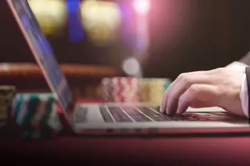 A professional dealer in a tuxedo greeting players at the roulette table, symbolizing the authentic live casino feel at LEGIONBED.