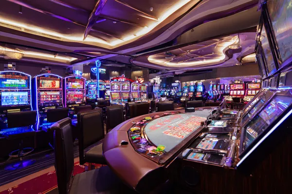A glowing roulette wheel with cascading chips, symbolizing the engaging live and instant-win games available on LEGIONBED.
