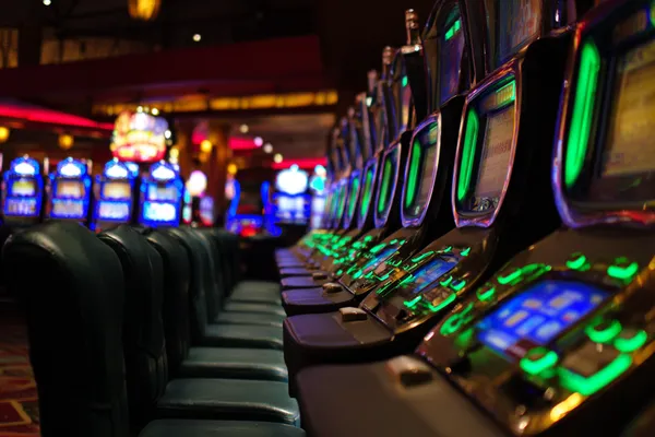 A woman in a luxurious green gown next to an ornate roulette wheel, capturing the upscale casino mood of LEGIONBED.